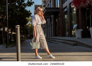 Stylish young woman standing on the street