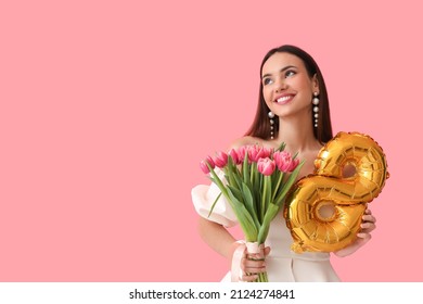 Stylish young woman with tulips and balloon in shape of figure 8 on pink background. International Women's Day