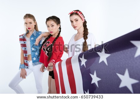 stylish young women posing with american flag in hands isolated on white, Independence Day concept
