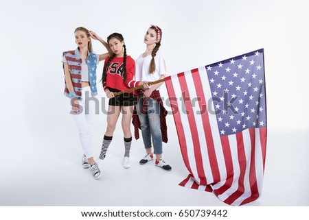 stylish young women posing with american flag in hands isolated on white, Independence Day concept