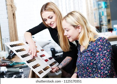 Stylist Helps Female Client To Choose Hair Dye Color With Hair Swatches Chart