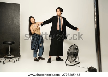 Stylist prepare model for a creative session, showcasing unique outfits and artistic flair.