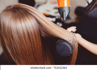 Stylist puts hair dryer and comb in hairdresser