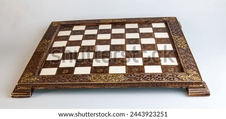 Stylized chess. Chessboard with metal inlay on a white background.