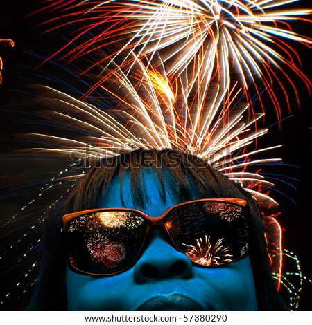 stylized facial portrait of a blue faced female with fireworks over head and reflecting off her shades