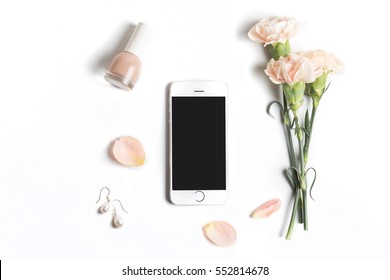 Stylized Feminine Flatlay With Nail Polish, Flowers, Petals, Ribbon And Smart Phone Mock Up Isolated On White Top View. Woman Accessories From Above