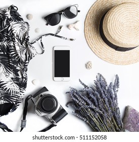 Stylized Feminine Flatlay With Swimming Suit, Sunglasses, Camera, Hat, Bunch Of Lavender, Crystal Stone, Sea Shells And Smart Phone Mock Up Isolated On White Top View. Woman Accessories From Above.