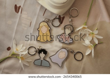Stylized Flat Design Keychains Featuring Abstract Human Figures Still Life