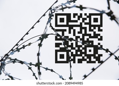 A stylized image of an OR code with barbed wire against a gray sky.