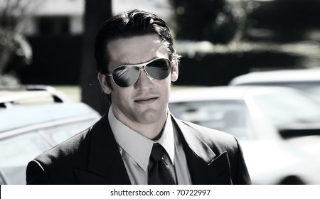 Stylized Portrait Of A Young Man In Suite And Sunglasses