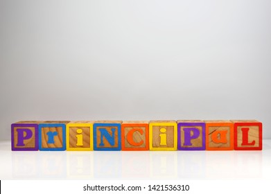 Stylized Shot Of “Principal” Spelled Out With ABC Blocks.