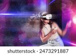 Stylized shot of young girl with VR goggles and controllers, immersed in futuristic virtual reality game with dynamic, colorful lights and cosmic visuals capturing excitement and thrill of experience