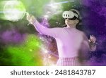 Stylized shot of young girl with VR goggles and controllers, immersed in futuristic virtual reality game with dynamic, colorful lights and cosmic visuals capturing excitement and thrill of experience