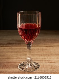 Stylized Wine Glass On Wooden Base