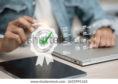 Stylus tapping tablet screen with digital quality badge and checklist icons. E‑certification and trust verification concept.