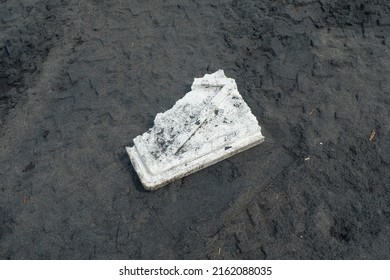 A styrofoam trash is on the beach sand