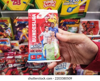 Subang Jaya, Malaysia - 10 September 2022 : Hand Hold A Pack Of TOPPS Match Attax Trading Card Game For Sell In The Supermarket With Selective Focus.