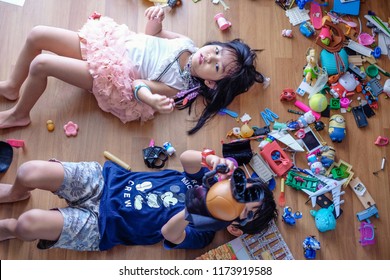 Subang Jaya, Malaysia - August 31, 2018 : Picture Of Kids Laying On Wooden Floor With Their Messy Toys.