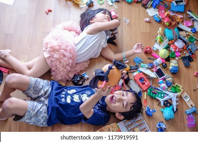 Subang Jaya, Malaysia - August 31, 2018 : Picture Of Kids Laying On Wooden Floor With Their Messy Toys.