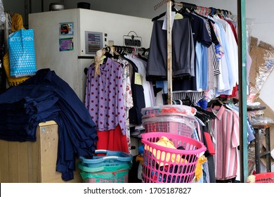 Subang Jaya, Malaysia - February 25 2020: Clothes Hanging Out Front Of A Dry Cleaning Shop Ready For Customer To Pick Them Up After Being Cleaned. Exterior Of Small Local Dhobi Shop Open For Business.