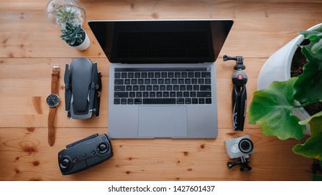 Subang Jaya, Malaysia - June 18, 2019 : Still life picture of laptop, drone and wrist watch on wooden table.