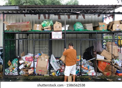 Subang Jaya, Malaysia - November 2, 2019: A Man Sorting Items To Put Into A Large Collection Cage At A Community Recycling Center Setup To Encourage People To Do Their Part To Help The Environment.