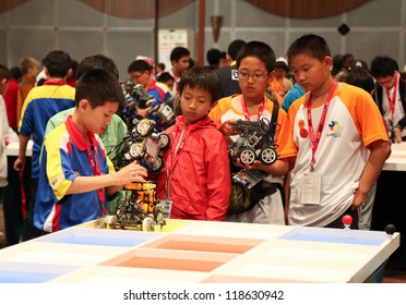 SUBANG JAYA - NOVEMBER 10: Unidentified Elementary Students Prepare Their Robot For The 'robot Organizer' Challenge At The World Robot Olympaid On November 10, 2012 In Subang Jaya, Malaysia.