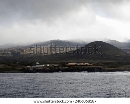 Sub-Antarctic Marion Island basecamp with the island mountains as a backdrop as seen from a distance out on the ocean. 
