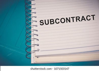 Subcontract word written on white paper
