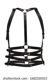Subject shot of a black leather harness made of multirow straps with rivets, steel rings and buckles. The chest harness is isolated on the white background.  