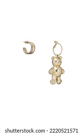Subject shot of golden asymmetric earrings. One earring is in the shape of an open ring, the other is in the shape of a teddy bear. The earrings are isolated on the white background. Front view.  - Shutterstock ID 2220521571