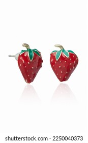 Subject shot of golden stud earrings made as strawberries decorated with bright colored enamel. The original earrings are isolated on the white background. Vogue accessory for ladies and girls. - Shutterstock ID 2250040373