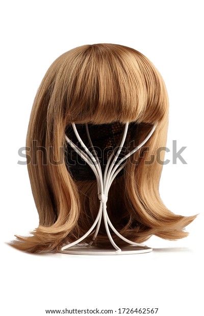Subject shot of a\
natural looking blonde wig with bangs and twisted strands fixed on\
the white metal wig holder. The stand with the wig is isolated on a\
white background.  