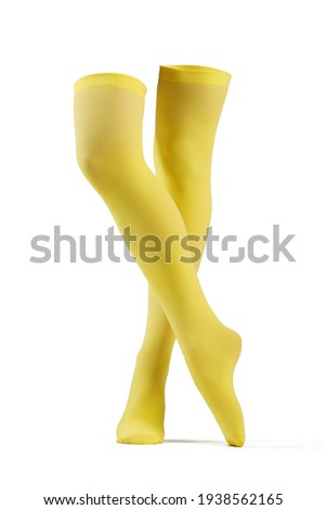 Subject shot of solid yellow opaque stockings without print. The legs are isolated on the white background.