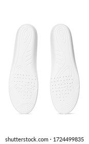 Subject shot two white insoles and sketchy feet drawings   ventilation holes the bottom  The orthotic insoles are isolated the white backdrop  