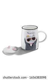 Subject Shot Of A White Ceramic Mug With A Picture Of A Dressed Up Cat In Sunglasses And Lettering 