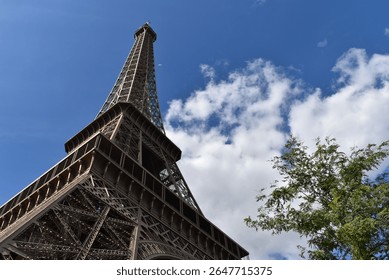 A sublime shot of the Eiffel Tower lit from the left, under a beautiful blue sky.