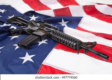 Submachine Gun On An American Flag With Stars And Stripes