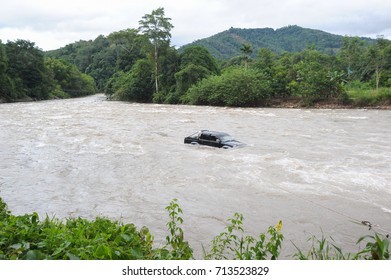 Submerged Car Stranded In The Middle Of Flooding River.