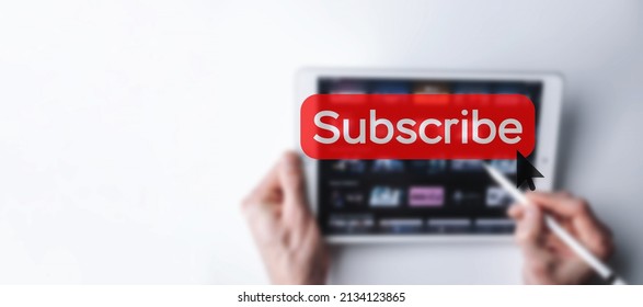 Subscribe button. Online video subscription red button. Internet service on laptop digital tablet blured banner background. Visual contents concept. Social networking service