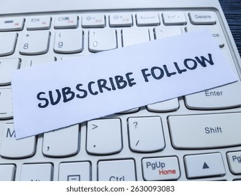 Subscribe follow writting on laptop keyboard background. - Powered by Shutterstock - Get 15% off with code: PIKWIZARD15