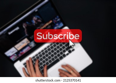 Subscribe now. Online video subscription red button. Internet service on laptop digital tablet blured technology background. Streaming video. Communication network - Powered by Shutterstock