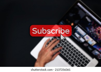 Subscribe now. Online video subscription red button. Internet service on laptop digital tablet blured technology background. Streaming video. Communication network - Powered by Shutterstock