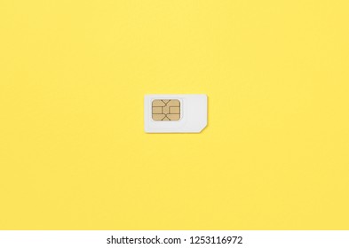 Subscriber Identity Module. White SIM Card On Yellow Background