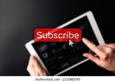 Subscription plan. Red online video subscribe button. Internet service on laptop digital tablet blured technology background. Visual contents concept. Social networking service - Powered by Shutterstock