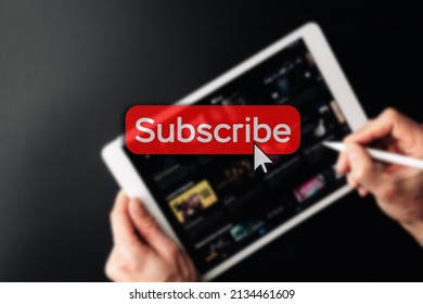 Subscription plan. Red online video subscribe button. Internet service on laptop digital tablet blured technology background. Visual contents concept. Social networking service - Powered by Shutterstock