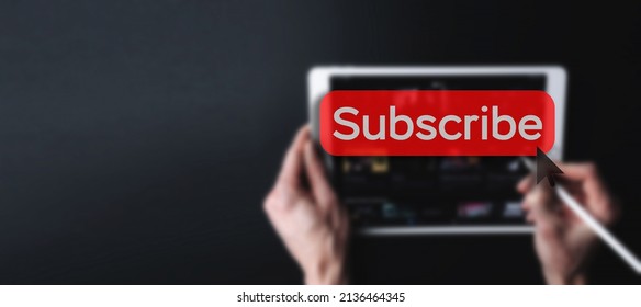 Subscription service. Online video red subscribe button. Internet service on laptop digital tablet blured banner background. Streaming video. Communication network