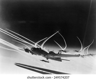 Sub-stratospheric Vapor trails of B-17 Flying Fortresses of the U.S. Army 8th Air Force. The curved trails were made by fighters accompanying the B-17s.Ca. 1944.