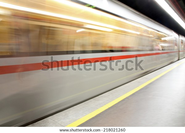 subterranean\
subway car arriving at the train\
station