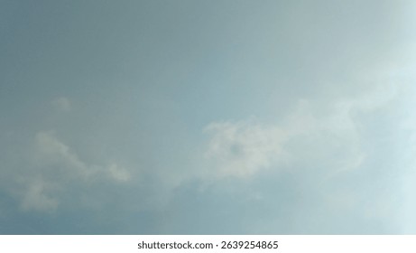 A subtle blue sky with soft, diffuse clouds, creating a calm and expansive background.